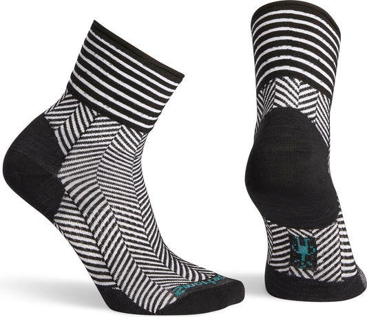 A pair of black and white striped socks with a zig zag pattern in the foot area and black accents on the heel and toe.