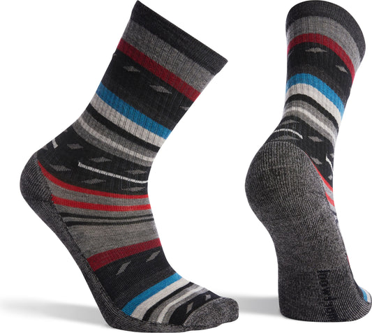 Two crew socks in gray with geometric and stripe patterns in black, red, blue, and white.