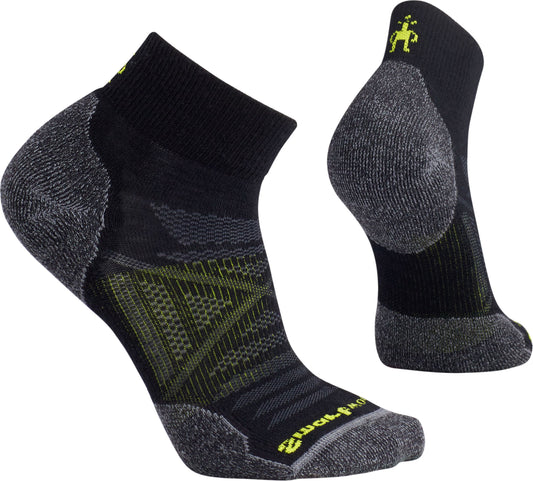 A pair of black athletic socks with gray heel and toe and yellow accents