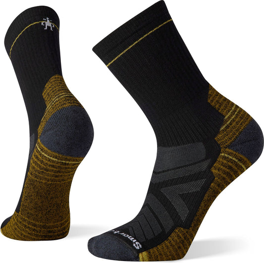 Pair of black and gold socks with gray reinforced areas, one laid out, one upright.
