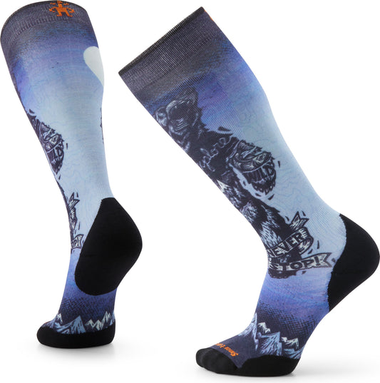 A pair of ski socks with a blue gradient background, a wolf graphic, and text 'NEVER STOP EXPLORING'.