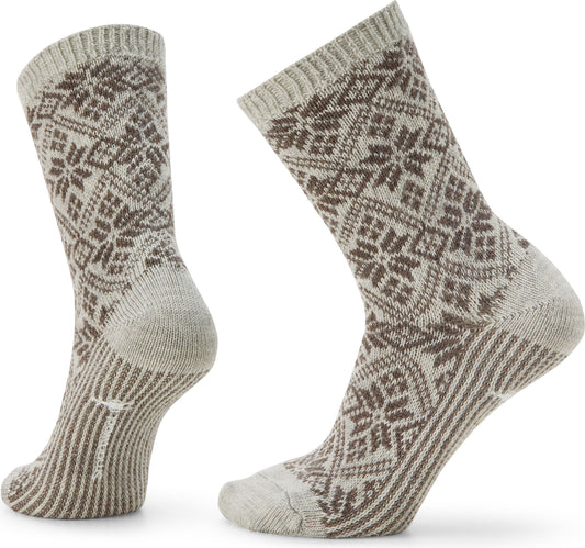 Pair of knit socks with a snowflake pattern in beige and brown.