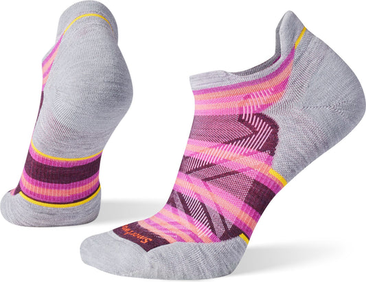 Pair of gray running socks, one standing on its heel, decorated with purple, pink, and orange stripes.