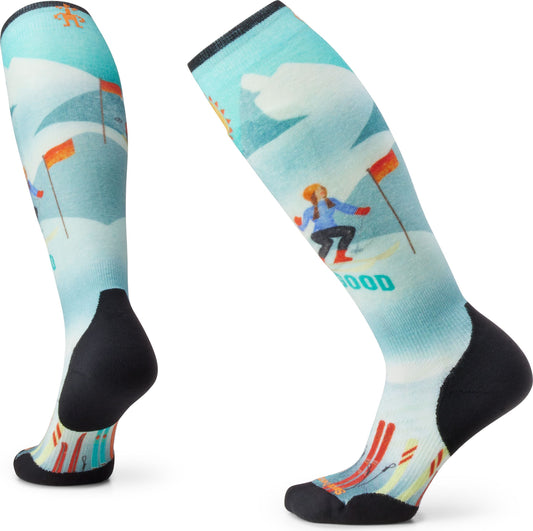 Ski socks with a whimsical skier design against a mountain backdrop, featuring orange flags and colorful skis at the base.
