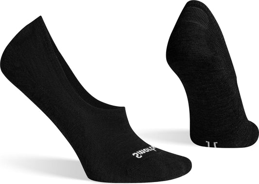Two black socks, one positioned on its side with the top facing left, the other stands upright with the back facing forward, revealing its heel.