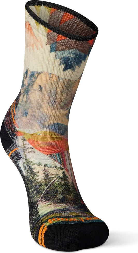Sock with an image of mountain landscape and an aztec pattern at the top.