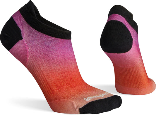 A pair of socks with a gradient from pink to orange with black heels and ankle bands.