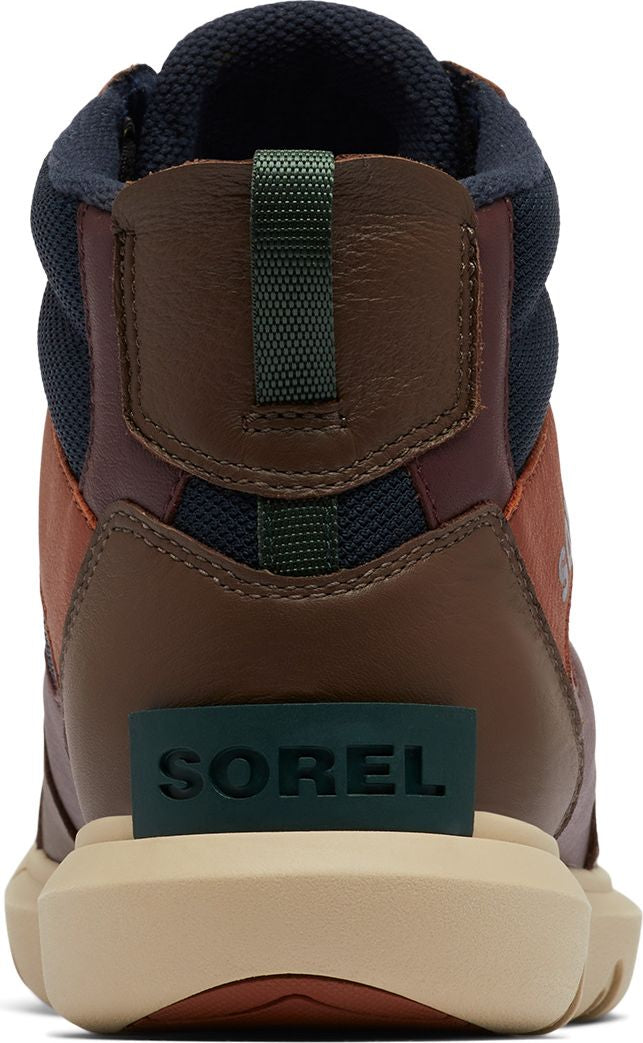 The back of a brown and burgundy high-top shoe with navy blue padding around the ankle. The word "SOREL" is printed in green near the sole of the shoe.