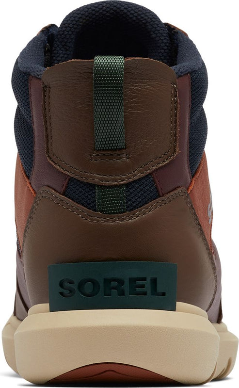 The back of a brown and burgundy high-top shoe with navy blue padding around the ankle. The word "SOREL" is printed in green near the sole of the shoe.