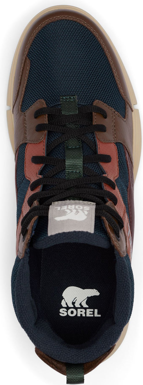 A top-down view of a navy, brown, and tan shoe with black laces and a white tongue label.