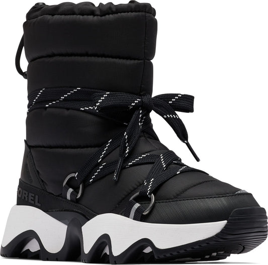 Black puffy snow boot with white and black laces and a white and black sole.