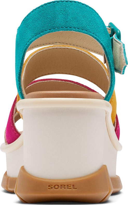 SOREL sandal features multi-colored straps in teal, yellow, and magenta, a platform sole, and a brown rubber outsole with the word "SOREL".