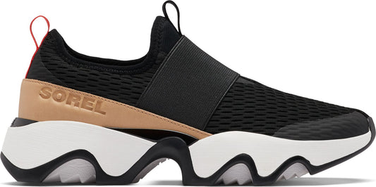 A black slip-on sneaker with a thick, sculpted white sole, a wide black elastic strap across the top, and a tan accent on the heel with the word "SOREL" embossed on it.