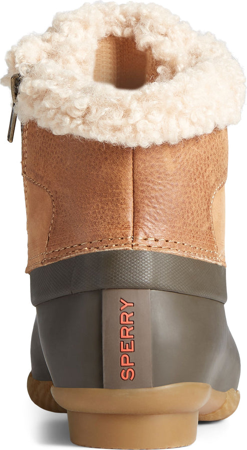 Rear view of an ankle-high tan and olive green rubber boot with a white fluffy lining. "SPERRY" is vertically printed in orange on the side.