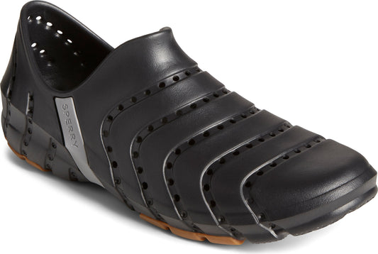 Black perforated slip-on shoe with a brown sole.