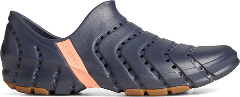 A blue rubber shoe with perforated detailing, a peach-colored stripe, and a brown sole.