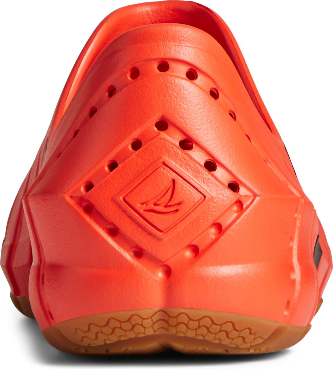 Back view of a slip-on clog-style shoe with round perforations and a diamond pattern containing a symbol on the heel, above a brown sole.