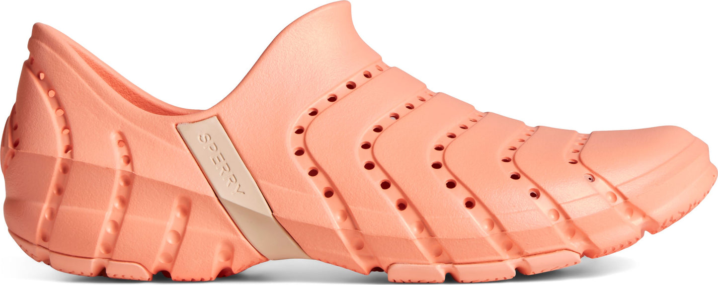 A salmon-colored slip-on shoe with a textured sole.