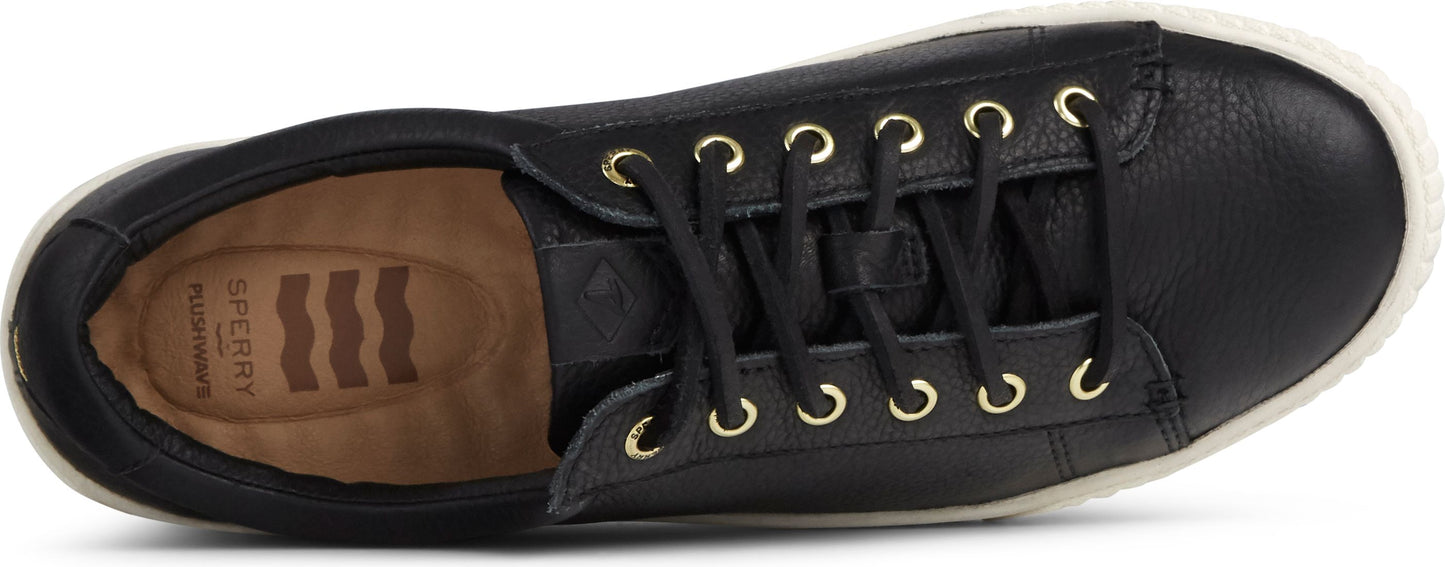 A black sneaker with gold eyelets and white soles.