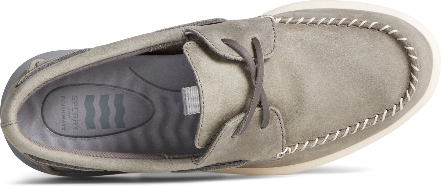 A top-down view of a boat shoe featuring gray leather and contrasting white stitching.