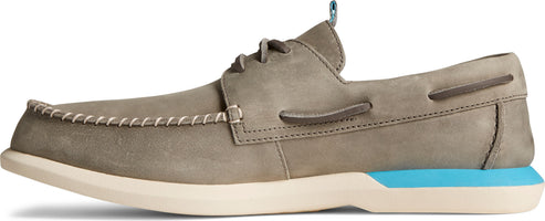 A tan boat shoe with a light tan sole and blue heel accent.