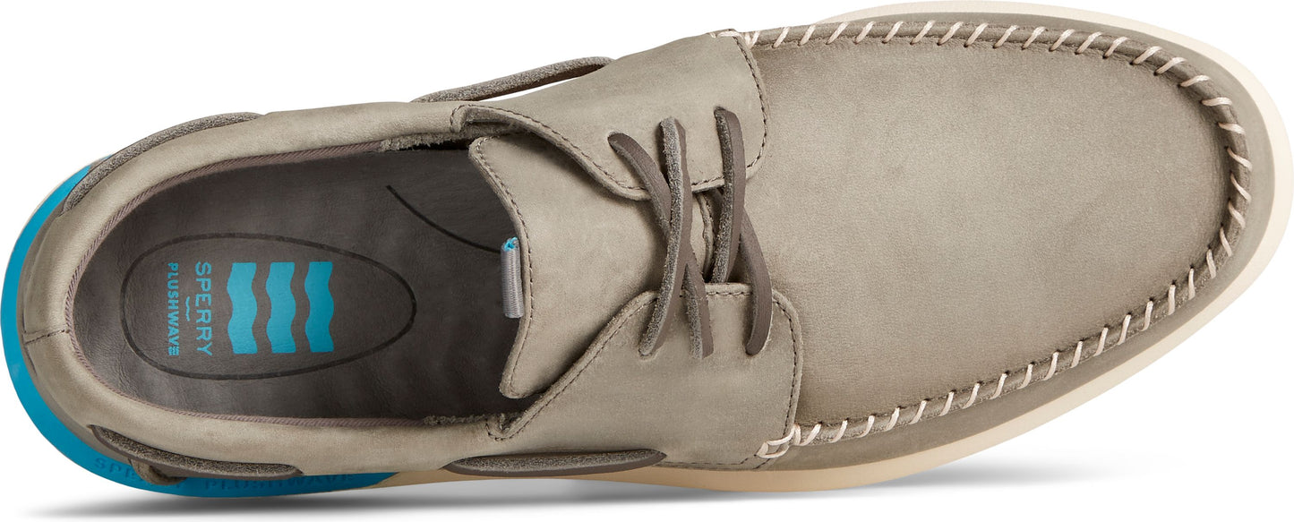 A boat shoe with laces and contrast stitching around the toe.