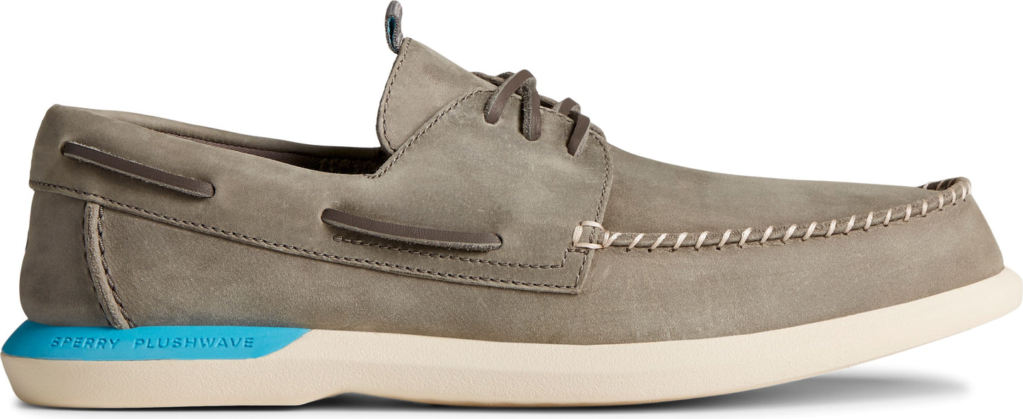 A grey boat shoe with white stitching and laces.