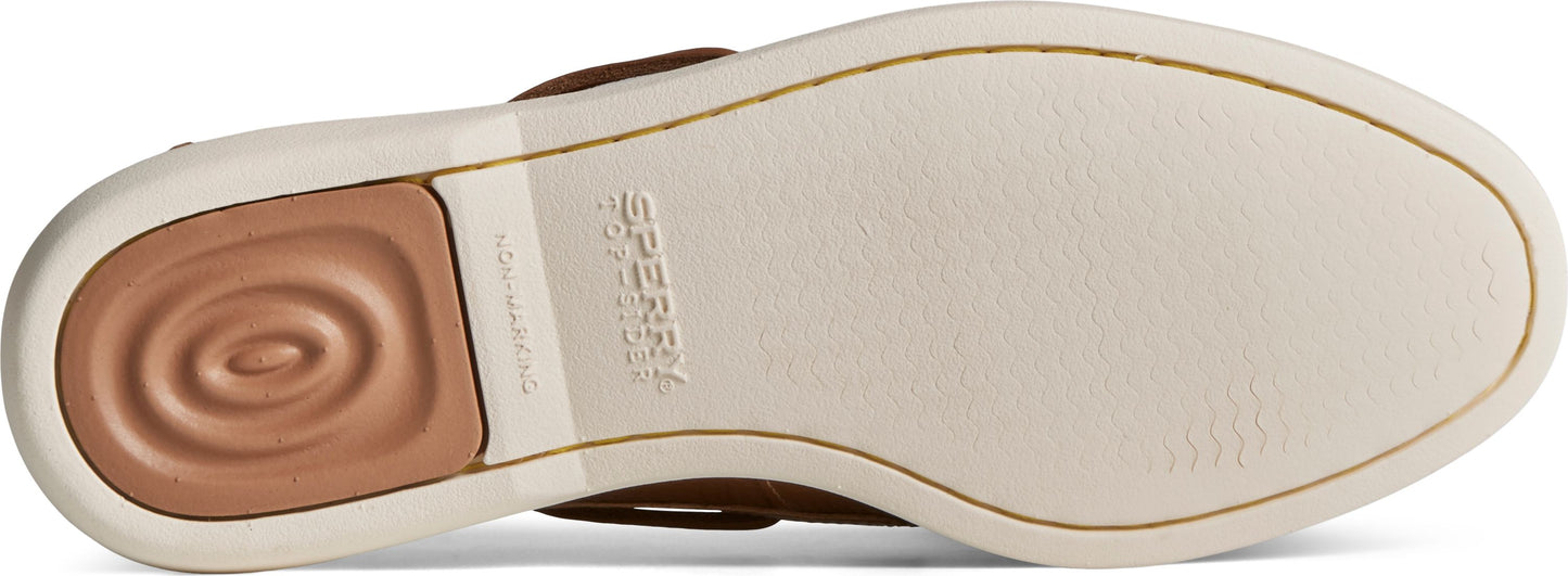 The underside of a shoe displays its non-marking sole with a circular wave tread and the brand's logo visible on the side.