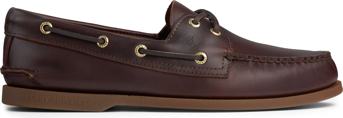 A brown leather boat shoe with a brown sole and gold eyelets.