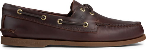 A brown leather boat shoe with a brown sole and gold eyelets.