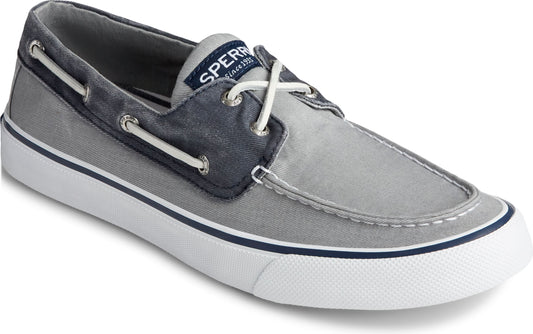 Gray and navy boat shoe with white laces and sole.