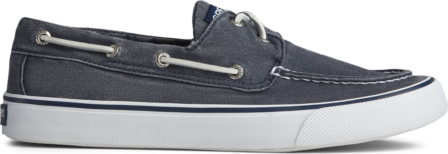 A blue boat shoe with white soles and laces.