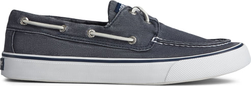 A blue boat shoe with white soles and laces.