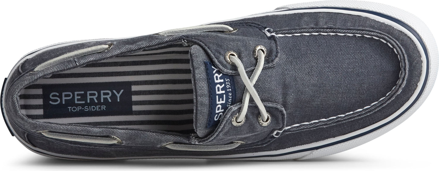 Top-down view of a boat shoe in a denim-like fabric with white laces and a white sole.
