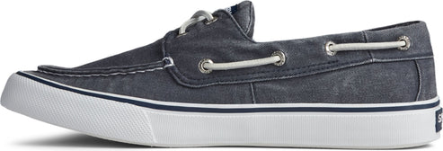 A blue canvas boat shoe with white laces and a white sole.