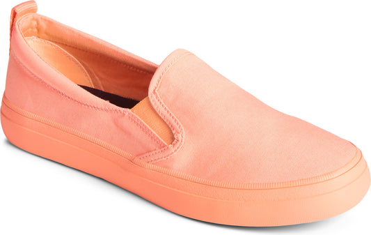 A coral colored slip-on sneaker.