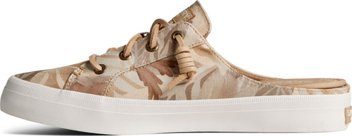 A slip-on sneaker with beige botanical print and white sole.
