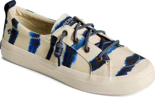 Beige canvas sneaker with blue tie dye stripes and blue laces.