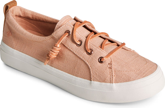A low-top pink fabric sneaker with a white rubber sole and light brown leather laces.
