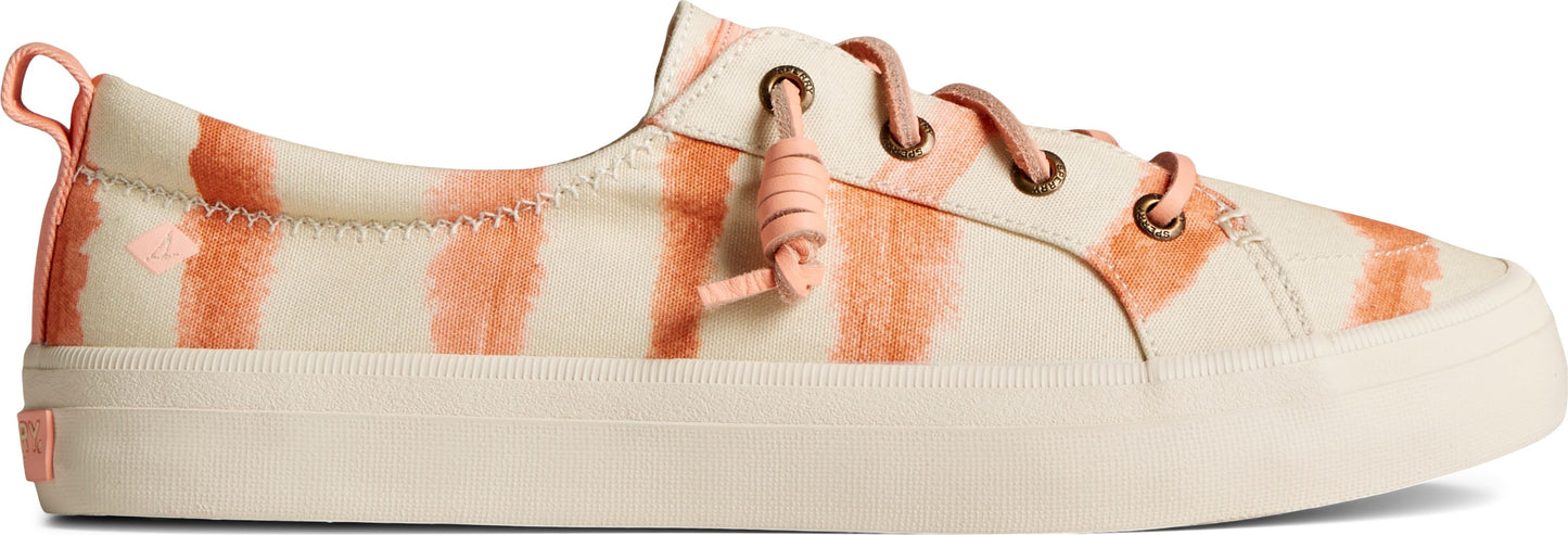 A canvas sneaker with salmon-colored tie-dye stripes.