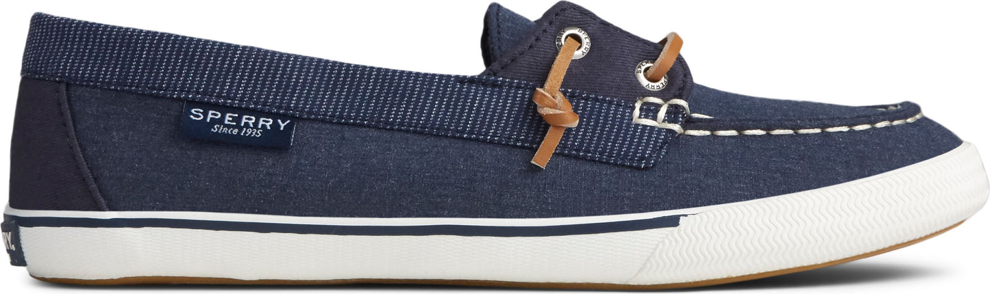 A Sperry canvas slip-on boat shoe in navy blue with brown leather laces.