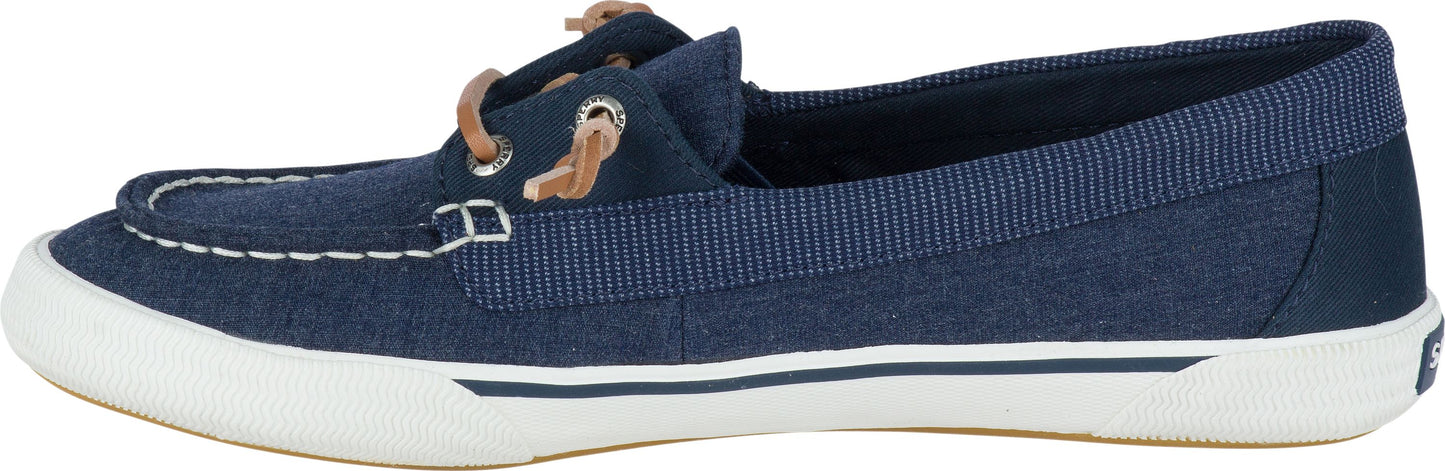 A side view of a blue boat shoe with white stitching and laces.