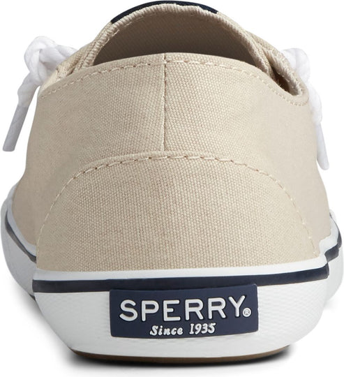 Beige canvas shoe with white laces, a white sole and a navy blue label at the heel that reads "SPERRY Since 1935".