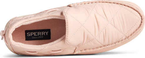 A close-up of a light-pink, quilted slipper.