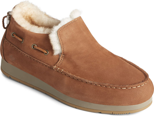 Slip-on moccasin style shoe with light brown suede exterior and furry off-white interior.