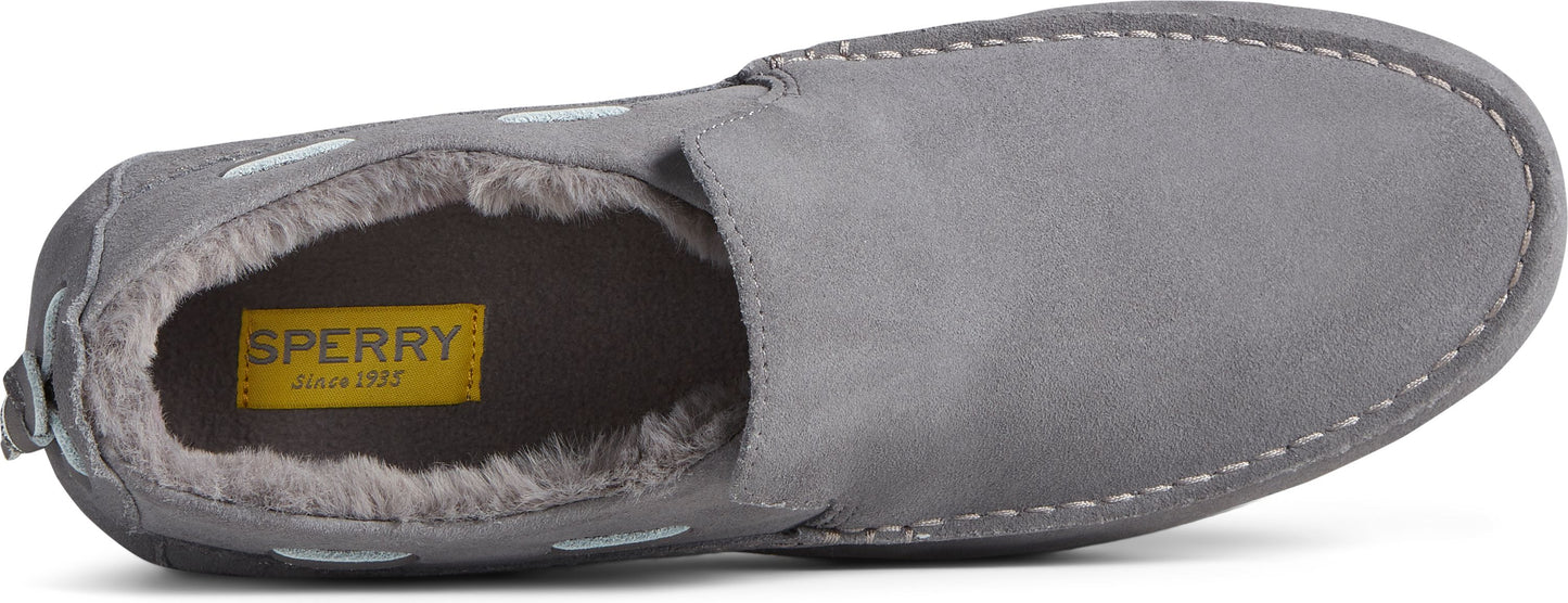 A gray slipper with white stitches. Inside the slipper, a yellow tag with 'SPERRY since 1935' text can be seen.