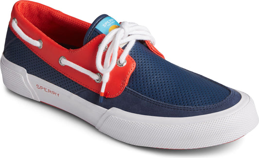 Close-up of a boat shoe, which has a blue perforated toe and vamp, red saddle and lining, white laces and midsole. The side of the shoe has the word, Sperry, in white letters.