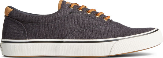 A shoe with a canvas upper, white midsole, and brown laces.