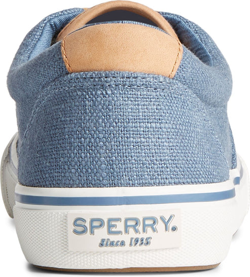 Rear view of a blue canvas sneaker with tan trim on the heel.