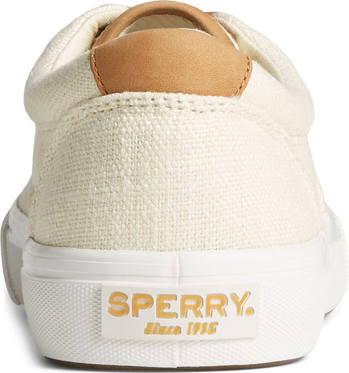 The back of a canvas cream colored shoe with leather heel accent and raised white sole with 'SPERRY since 1935' in tan text.